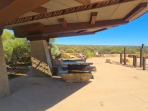 Shaded picnic area at Kalbarri Skywalk with stone tables and outback views